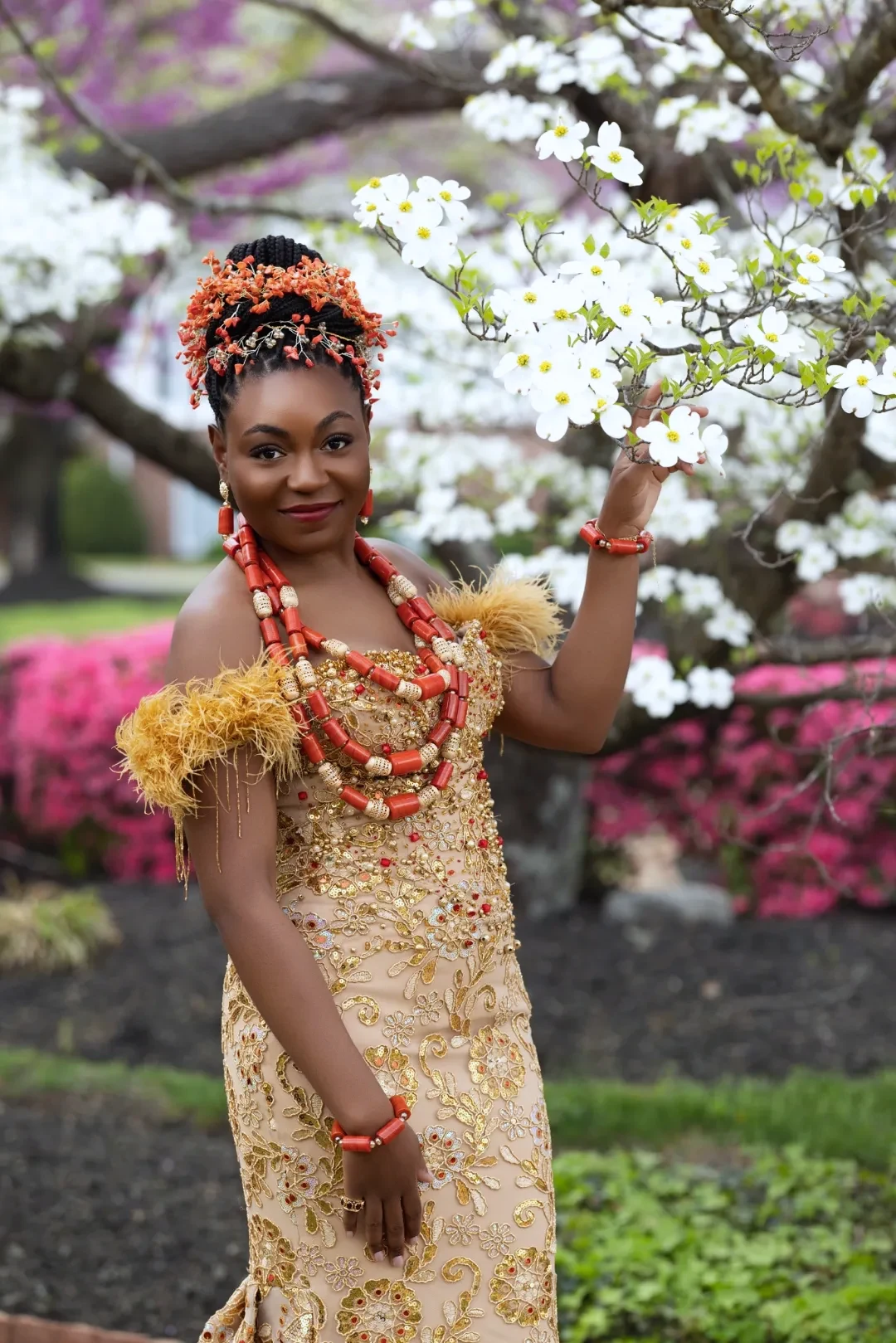 Close-up traditional wedding portrait with coral beaded headpiece and layered necklaces